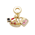 One MCB charm assembly with hat, handbag, lipstick and large attached bracelet ring on a transparent background — CHARMS-00855